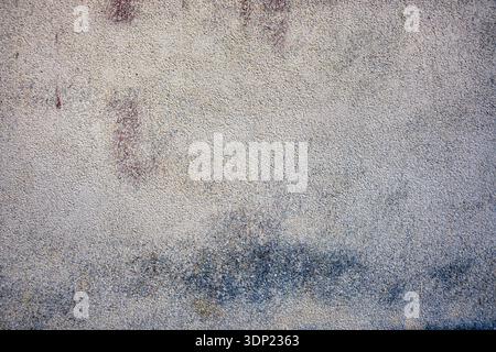Smooth structural plaster wall texture. Light yellow, pale beige and brownish tones with subtle dark spots. Even uniform decorative stucco background. Stock Photo