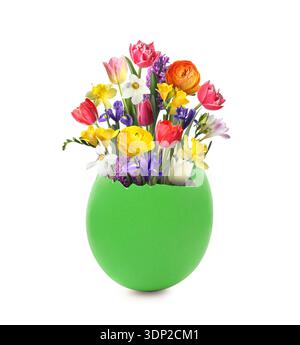 Cracked Easter eggshell with spring flowers on white background Stock Photo