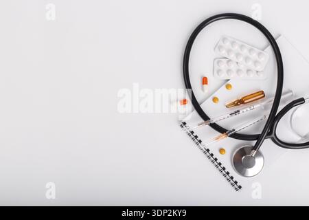 Medical objects flat lay white background syringes pills and ampoule Stock Photo