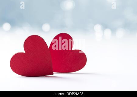 Two Hearts over blue blurred background with space for text. Valentine's day or anniversary card Stock Photo