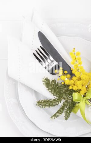 Spring table setting with mimosa easter holidays dinner Stock Photo