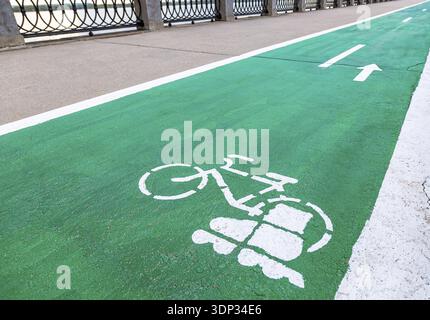 Dedicated bicycle lane with bicycle and roller skates sign, designed to make cycling safer on the asphalt road Stock Photo
