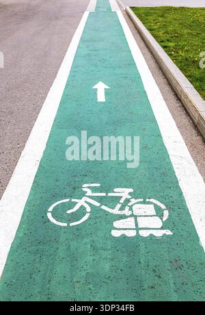Dedicated bicycle lane with bicycle and roller skates sign, designed to make cycling safer on the asphalt road Stock Photo