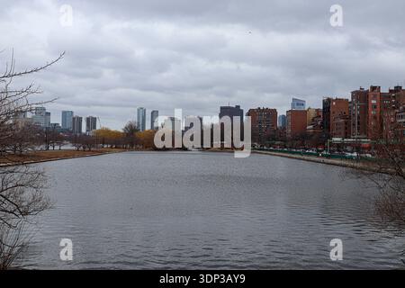 Wide view of Boston city skyline across Charles River under dramatic cloudy sky. Stock Photo