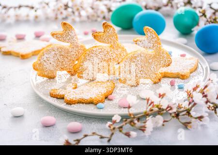 Easter bunny almond cookies and Easter eggs on decorated festive table Stock Photo