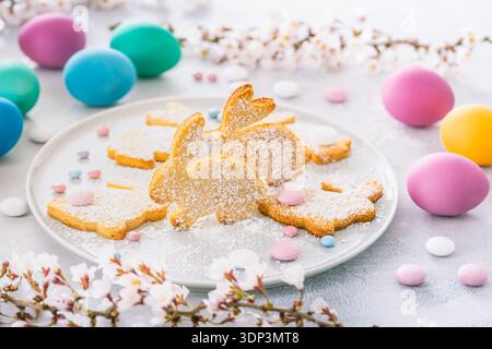 Easter bunny almond cookies and Easter eggs on decorated festive table Stock Photo