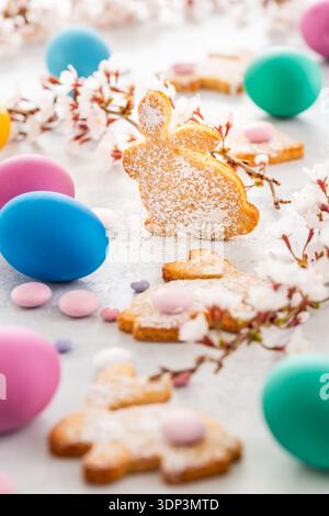 Easter bunny almond cookies and Easter eggs on decorated festive table Stock Photo