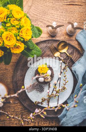 Overhead view of an Easter place setting with Easter eggs and flowers Stock Photo