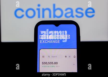 In this photo illustration, The Coinbase logo is displayed on a mobile ...
