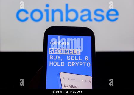 In this photo illustration, The Coinbase logo is displayed on a mobile ...