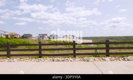 Wide View of Suburban Development and Fence Stock Photo