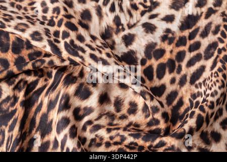 Abstract leopard texture background. Cotton fabric with fashionable print. Wild animal print cotton cloth sample. Stock Photo