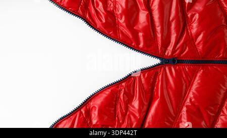 Open blue zipper on red winter down jacket on light background with copy space Stock Photo