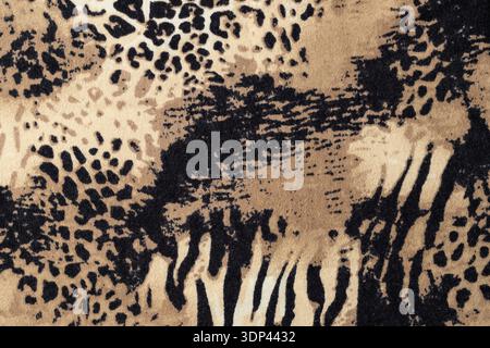 Animal mixed leopard and zebra print on elastic fabric as background. Abstract wild animal print knitwear sample. Stock Photo