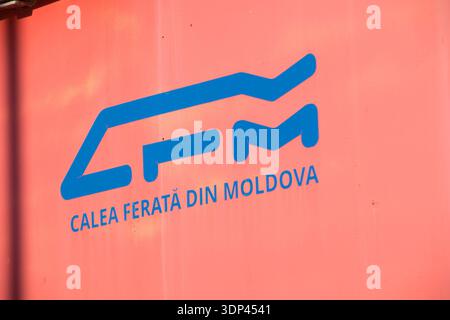 Trains arrive and depart at the Chisinau Moldova station in winter. The station is busy with passengers and railway signs visible. Stock Photo