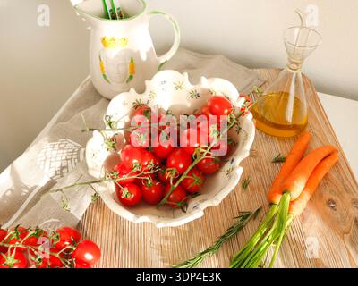 Fresh cherry tomatoes in vintage bowl on wooden board. Food and agricultural products. Healthy food and vegetables.  Stock Photo