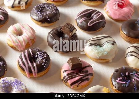 Mini donuts covered in chocolate on a white background. Close-up Stock Photo