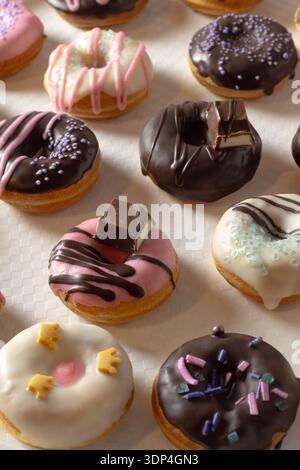 Mini donuts covered in chocolate on a white background. Close-up Stock Photo