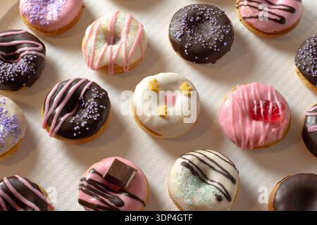 Mini donuts covered in chocolate on a white background. Close-up Stock Photo