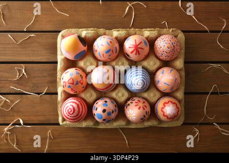 Colorful Hand-Painted Easter Eggs in Carton Stock Photo