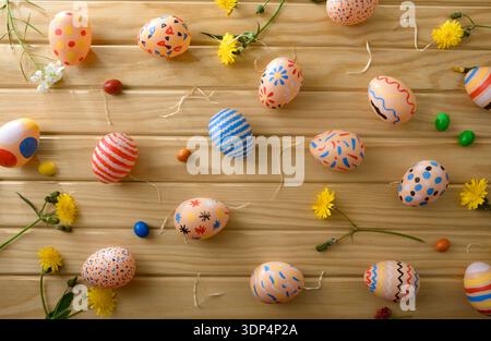 Scattered Colorful Easter Eggs on Wooden Background Stock Photo