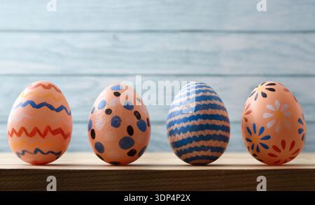 Hand-Painted Easter Eggs on Wooden Background Stock Photo