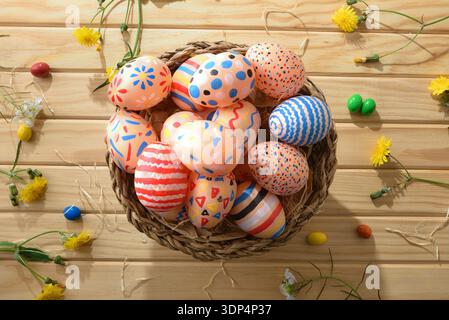 Colorful Easter Eggs in Rustic Wicker Basket Stock Photo