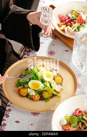 salad with eggs Benedict and herbs Stock Photo