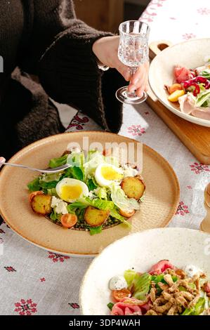 salad with eggs Benedict and herbs Stock Photo