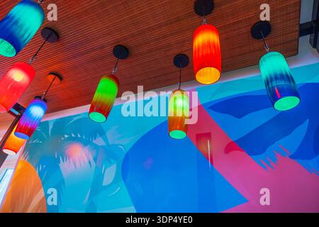 Beautiful view of colorful hanging lamps on ceiling in modern cafe interior with bright decorative lighting. Miami Beach. USA. Stock Photo