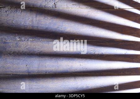 Soft bluish gray wooden planks with subtle grain and long horizontal shadows. Minimalist and calm texture with atmospheric lighting Stock Photo