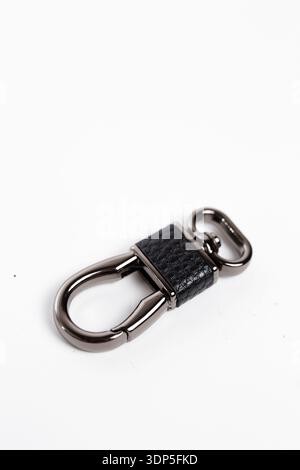 Stylish black leather and metal carabiner keychain isolated on white, perfect for bags, keys, and everyday accessories. Stock Photo