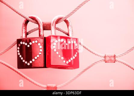 Two grungy love padlocks with heart decoration attached to the bridge in Paris. Valentine's day background. Toned photo. Stock Photo