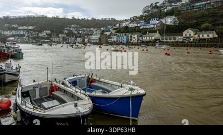 Picturesque harbour scene in Looe with colourful fishing boats moored along the River Looe. Stock Photo