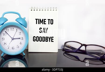 It says on a white notebook It's time to say goodbye Stock Photo
