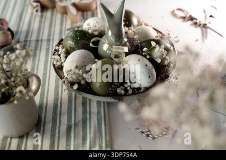 Rustic Easter still life with olive eggs and decor. Stock Photo