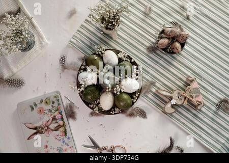 Rustic Easter still life with olive eggs and decor. Stock Photo