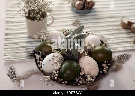 Rustic Easter still life with olive eggs and decor. Stock Photo