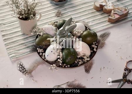 Rustic Easter still life with olive eggs and decor. Stock Photo