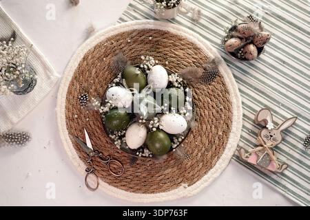 Rustic Easter still life with olive eggs and decor. Stock Photo
