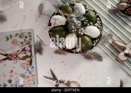 Rustic Easter still life with olive eggs and decor. Stock Photo