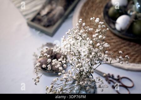 Rustic Easter still life with olive eggs and decor. Stock Photo