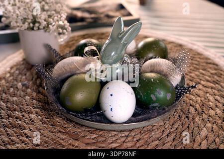 Rustic Easter still life with olive eggs and decor. Stock Photo