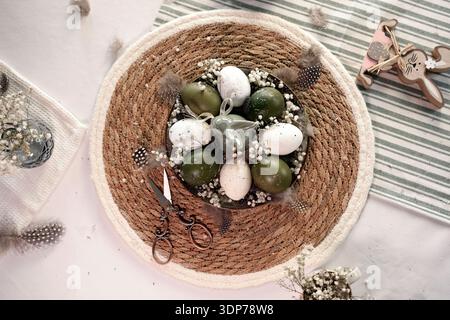 Rustic Easter still life with olive eggs and decor. Stock Photo