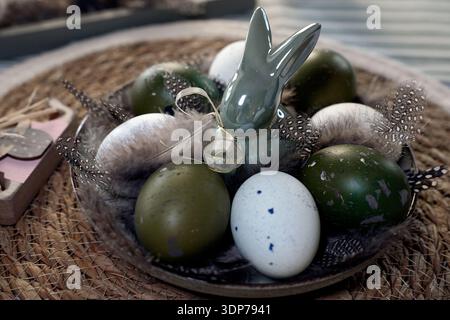 Rustic Easter still life with olive eggs and decor. Stock Photo