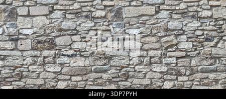 Stone wall showing irregular blocks creating a textured architectural background Stock Photo