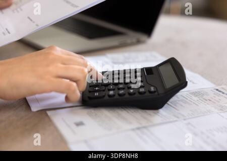 Accountant woman checking financial report on calculator Stock Photo