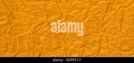 Orange Crumpled Paper Texture Background with Wrinkled Surface Pattern Stock Photo