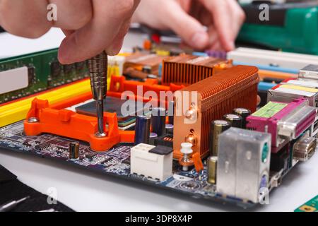 Engineer checking motherboard with multimeter Stock Photo