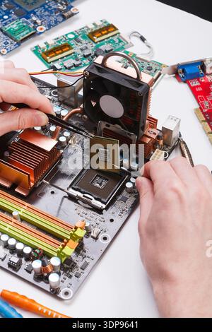 Technician plug in microprocessor to motherboard Stock Photo
